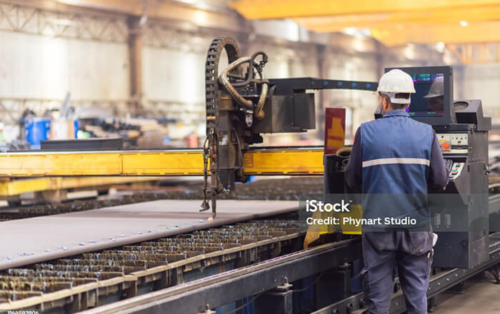 A worker wearing a hardhat in a factory setting