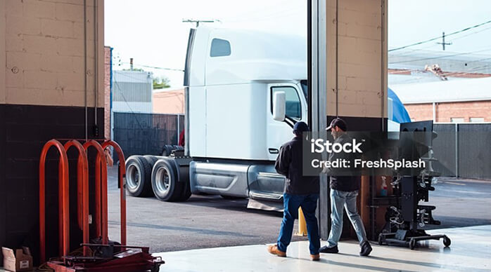 Two men walking towards a truck
