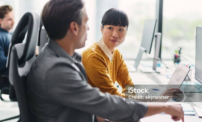 A woman sat next to a man, looking toward him