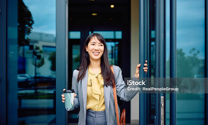 A woman in business attire leaving a building